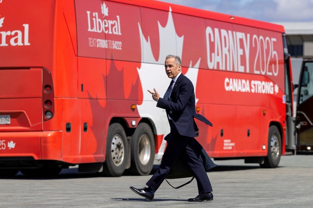 Canada's Prime Minister Mark Carney walks towards his bus after getting off his plane in Halifax Stanfield International Airport during his Liberal Party election campaign tour in Goffs, Nova Scotia, Canada April 21, 2025. REUTERS/Carlos Osorio