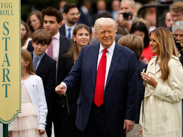 WASHINGTON, DC - APRIL 21: U.S. President Donald Trump and First Lady Melania Trump prepare to blow whistles durning the White House Egg Roll on the South Lawn on April 21, 2025 in Washington, DC. The White House is expecting thousands of children and adults to participate in the annual tradition of rolling colored eggs down the White House lawn, a tradition started by President Rutherford B. Hayes in 1878. (Photo by Chip Somodevilla/Getty Images)