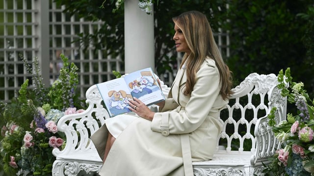 US First Lady Melania Trump reads a book to children and guests during the annual Easter Egg Roll on the South Lawn of the White House on April 21, 2025, in Washington, DC. 