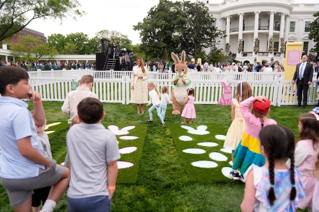 First lady Melania Trump talks with children as they play a game of hopscotch during the White House Easter Egg Roll on the South Lawn of the White House, Monday, April 21, 2025, in Washington. (AP Photo/Mark Schiefelbein)