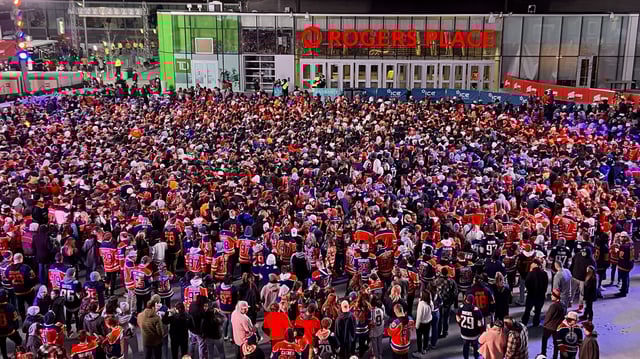 Oilers fans in the Edmonton Ice District Plaza celebrate a Game 2 win over the Los Angeles Kings on Wednesday, April 19, 2023 in the first round of the NHL playoffs.