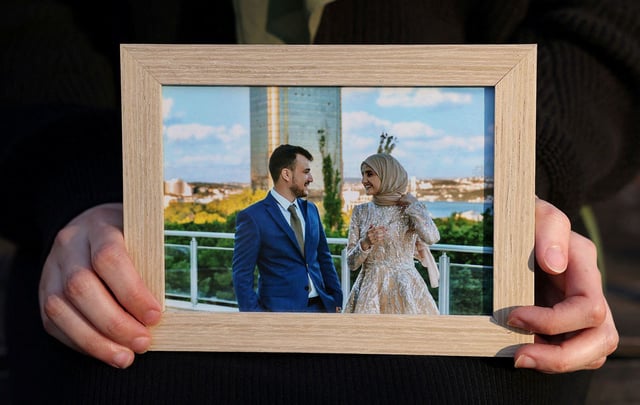 Noor Abdalla, 28, wife of Palestinian activist and Columbia University graduate student Mahmoud Khalil who was detained by ICE, holds a photograph of their wedding day after an interview with Reuters in New York City, U.S., March 12, 2025. REUTERS/Caitlin Ochs 
NO RESALES. NO ARCHIVES