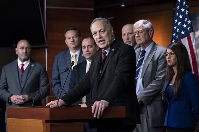 FILE - Rep. Andy Biggs, R-Ariz., center, speaks as members of the House Freedom Caucus hold a news conference at the Capitol in Washington, on March 10, 2023. From left are Rep. Clay Higgins, R-La., Rep. Michael Cloud, R-Fla., Rep. Bob Good, R-Va., Rep. Andy Biggs, R-Ariz., Rep. Chip Roy, R-Texas, Rep. Ralph Norman, R-S.C., and Rep. Lauren Boebert, R-Colo. (AP Photo/J. Scott Applewhite, File)
