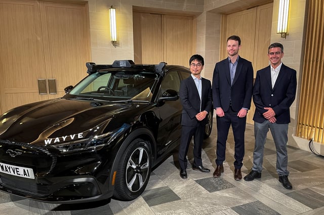 Executives from UK self-driving startup Wayve and SoftBank attend an event in Tokyo, Japan, April 22, 2025. REUTERS/Daniel Leussink