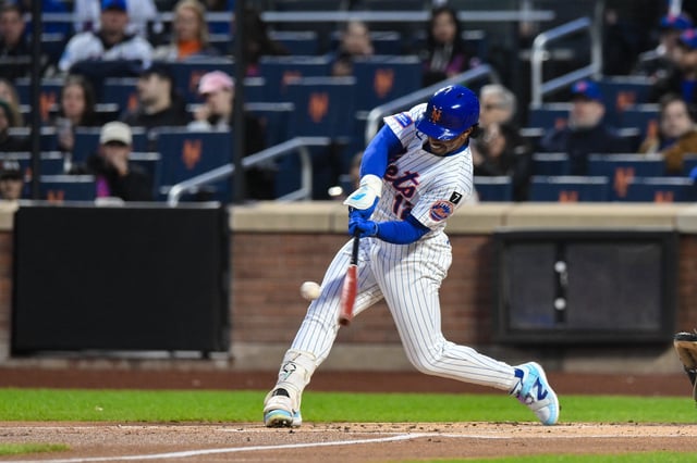 Apr 21, 2025; New York City, New York, USA; New York Mets shortstop Francisco Lindor (12) hits a solo home run against the Philadelphia Phillies during the first inning at Citi Field. Mandatory Credit: John Jones-Imagn Images