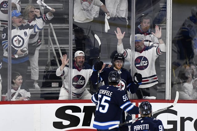 Winnipeg Jets' Kyle Connor (81) celebrates his goal against the St. Louis Blues with Mark Scheifele (55) during third period NHL playoff action in Winnipeg, Monday April 21, 2025. THE CANADIAN PRESS/Fred Greenslade