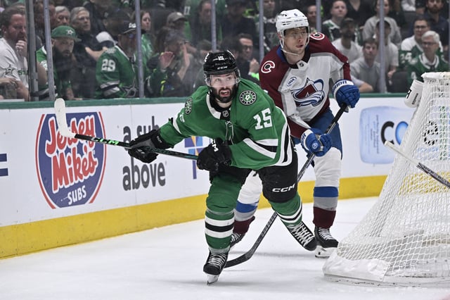 Apr 21, 2025; Dallas, Texas, USA; Dallas Stars center Colin Blackwell (15) and Colorado Avalanche defenseman Erik Johnson (6) chase the puck during the overtime period in game two of the first round of the 2025 Stanley Cup Playoffs at American Airlines Center. Mandatory Credit: Jerome Miron-Imagn Images