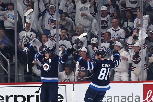 Apr 21, 2025; Winnipeg, Manitoba, CAN;Winnipeg Jets center Mark Scheifele (55) celebrates a goal against the St. Louis Blues with Winnipeg Jets left wing Kyle Connor (81) in the first period in game two of the first round of the 2025 Stanley Cup Playoffs at Canada Life Centre. Mandatory Credit: James Carey Lauder-Imagn Images