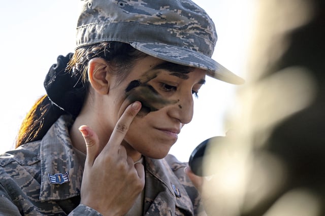 La Quinta High JROTC Audrina Espinoza, 16, applies camouflage face paint as she participates in the Army Career Fair at the Armed Forces Reserve Center near Moreno Valley, Calif., on Tuesday, Oct. 24, 2023.