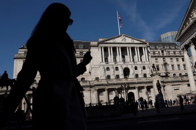 People walk near the Bank of England building in London, Britain, March 19, 2025. REUTERS/Carlos Jasso/File Photo