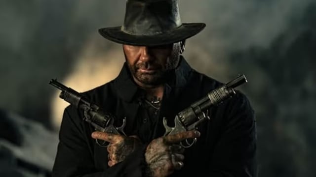 Dave Bautista holding twin guns in In the Lost Lands.