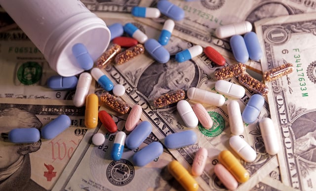 U.S. dollar banknotes and medicines are seen in this illustration taken, June 27, 2024. REUTERS/Dado Ruvic/Illustration