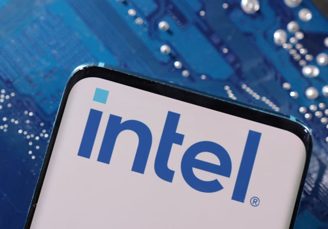 A smartphone with a displayed Intel logo is placed on a computer motherboard in this illustration taken March 6, 2023. REUTERS/Dado Ruvic/Illustration/File Photo