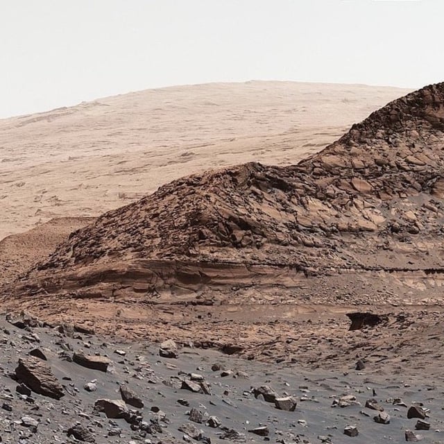 NASA's Curiosity rover explores a sulfate region in Mars' Gale Crater in August 2022, with upper Mount Sharp in the distance.