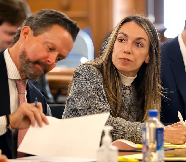 Defendant Karen Read and attorney Alan Jackson review jury questionnaires during the second day of jury selection in Read's retrial at Norfolk Superior Court in Dedham, Mass. on April 2, 2025.