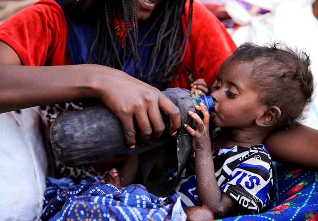 A severely malnourished child drinks from a bottle, at a camp for internally displaced people in Afdera town, Afar region, Ethiopia, February 23, 2022. REUTERS/Tiksa Negeri/File Photo