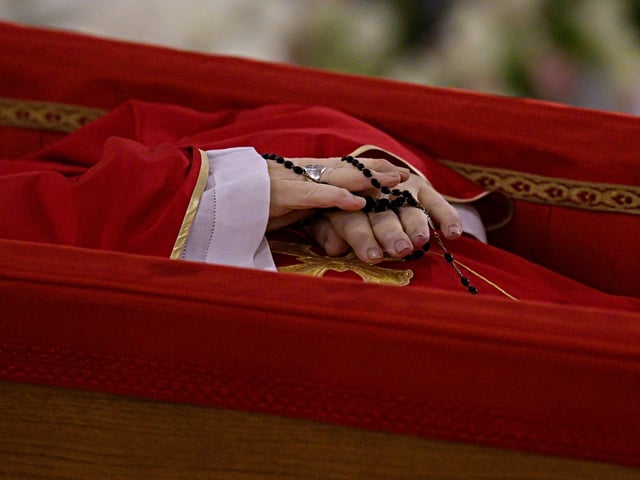 VATICAN CITY, VATICAN - APRIL 21: (EDITOR NOTE: STRICTLY EDITORIAL USE ONLY - NO MERCHANDISING). (EDITORS NOTE: This image depicts death.) The body of Pope Francis (hands detail) lies in state at the chapel of Casa Santa Marta during the Rite of Certification of Death presided by Cardinal Kevin Farrell on April 21, 2025 in Vatican City, Vatican. The Vatican announced that Pope Francis, 88, died "this morning at 07:35 local time (05:35 GMT) the Bishop of Rome, Francis, returned to the home of the Father". His death comes after he appeared in St Peter's Square yesterday, wishing thousands of worshippers "Happy Easter." (Photo by Vatican Media via Vatican Pool/Getty Images)