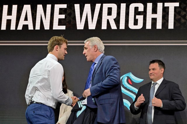Jul 7, 2022; Montreal, Quebec, CANADA; Shane Wright shakes hands with Seattle Kraken general manager Ron Francis after being selected as the number four overall pick to the Seattle Kraken in the first round of the 2022 NHL Draft at Bell Centre. Mandatory Credit: Eric Bolte-USA TODAY Sports/ File Photo