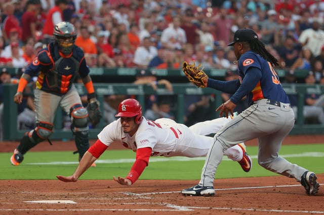 ST LOUIS, MISSOURI - JUNE 27: Nolan Arenado #28 of the St. Louis Cardinals scores a run ahead of the tag by Framber Valdez #59 of the Houston Astros in the fifth inning at Busch Stadium on June 27, 2023 in St Louis, Missouri.