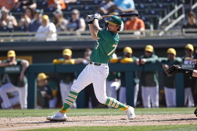MESA, AZ - FEBRUARY 25: Nick Kurtz #77 of the Athletics bats during a spring training game against the San Francisco Giants at HoHoKam Stadium on February 25, 2025 in Mesa, Arizona.