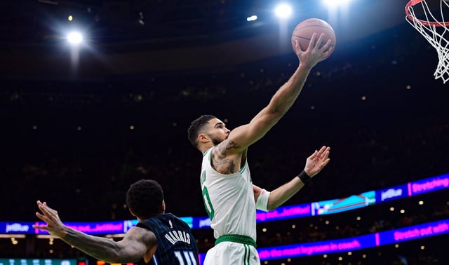 Apr 20, 2025; Boston, Massachusetts, USA; Boston Celtics forward Jayson Tatum (0) drives to the basket past Orlando Magic guard Gary Harris (14) during the second half at TD Garden. Mandatory Credit: Bob DeChiara-Imagn Images