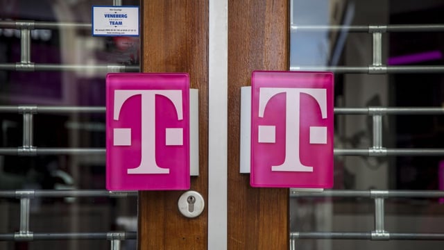 The T-Mobile logo on the doors of a T-Mobile store.