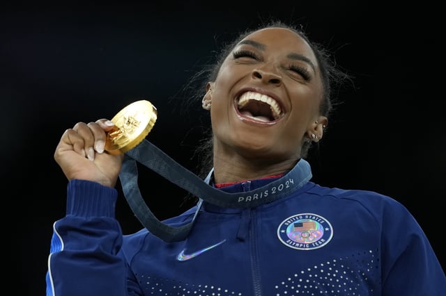 FILE – Simone Biles, of the United States, celebrates winning the gold medal during the medal ceremony in the women’s artistic gymnastics individual vault finals at Bercy Arena at the 2024 Summer Olympics, Aug. 3, 2024, in Paris, France. 
