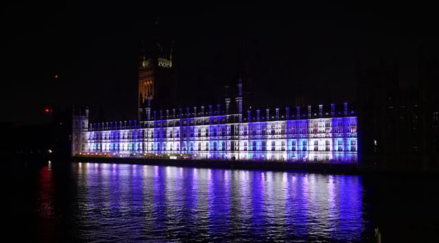 The Palace of Westminster, the home of the U.K. houses of parliament in London, is lit up in the colors of Israel's flag for victims and hostages of Hamas attacks, Oct. 9, 2023. (Lucy North/PA Images via Getty Images)