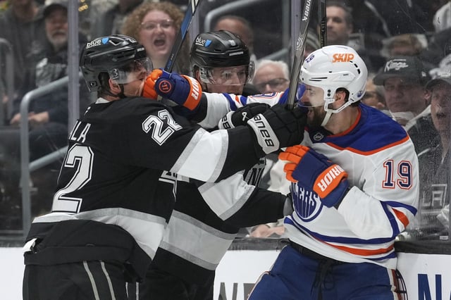 Los Angeles Kings left wing Kevin Fiala, left, and Edmonton Oilers centre Adam Henrique scuffle during the third period in Game 1 of an NHL hockey first-round playoff series Monday, April 21, 2025, in Los Angeles. 