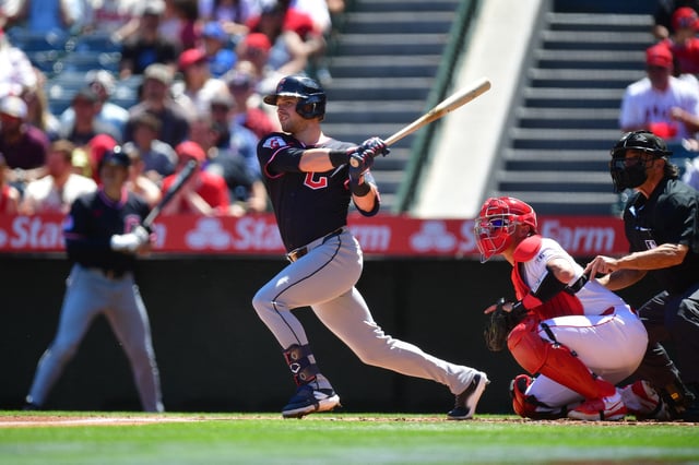 Apr 6, 2025; Anaheim, California, USA; Cleveland Guardians center fielder Lane Thomas (8) hits a sacrifice RBI against the Los Angeles Angels during the first inning at Angel Stadium. Mandatory Credit: Gary A. Vasquez-Imagn Images/File Photo