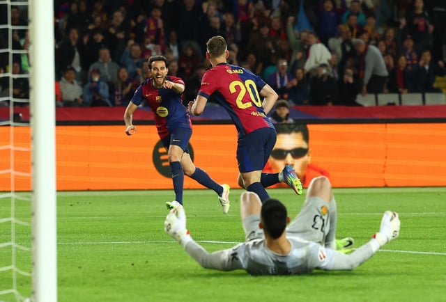 Soccer Football - LaLiga - FC Barcelona v RCD Mallorca - Estadi Olimpic Lluis Companys, Barcelona, Spain - April 22, 2025 FC Barcelona's Dani Olmo celebrates scoring their first goal with Eric Garcia as RCD Mallorca's Leo Roman looks dejected REUTERS/Albert Gea