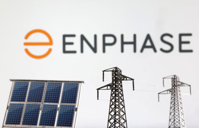 Miniatures of solar panel and electric pole are seen in front of Enphase logo in this illustration taken January 17, 2023. REUTERS/Dado Ruvic/Illustration