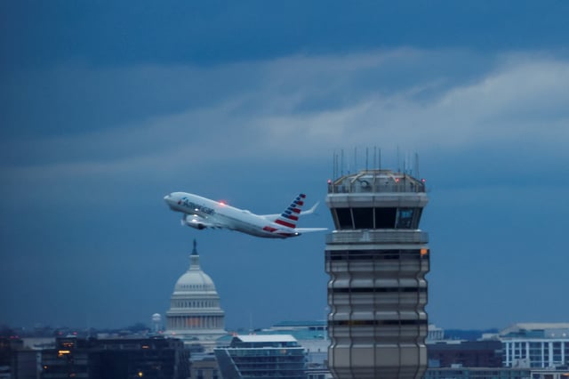 An American Airlines plane departs the Ronald Reagan Washington National, in the aftermath of the collision of American Eagle flight 5342 and a Black Hawk helicopter that crashed into the Potomac River, with the Capitol dome in the background, as seen from Virginia, U.S., February 1, 2025. REUTERS/Eduardo Munoz/File Photo