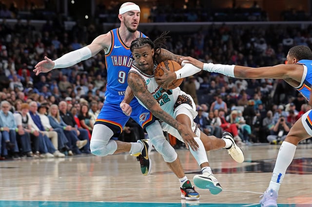 Ja Morant #12 of the Memphis Grizzlies goes to the basket between Alex Caruso #9 of the Oklahoma City Thunder and Shai Gilgeous-Alexander #2 of the Oklahoma City Thunder during the first half at FedExForum on February 08, 2025 in Memphis, Tennessee.