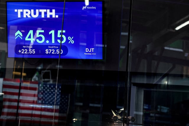 A screen displays trading information about shares of Truth Social and Trump Media & Technology Group, outside the Nasdaq Market site in New York City, U.S., March 26, 2024. REUTERS/Brendan McDermid/File Photo