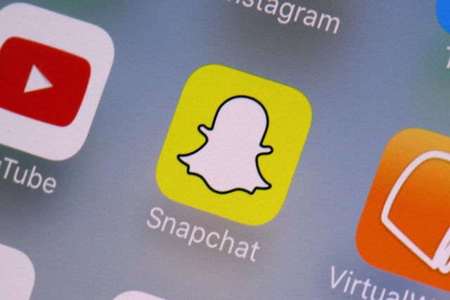 FILE – The Snapchat app on a mobile device is seen in New York. Snap Inc., Wednesday, Aug. 9, 2017. The owner of Snapchat will pay $15 million to settle a lawsuit brought by California’s civil rights agency that claimed the company discriminated against female employees, failed to prevent workplace sexual harassment and retaliated against women who complained. (AP Photo/Richard Drew, File)
