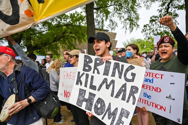 Protestors can be seen holding signs as they march towards the White House during a Free Kilmar Abrego and a nationwide &#34;Hands Off!&#34; protest against US President Donald Trump&#39;s policies and executive actions, in Washington, DC, April 19, 2025. (Photo by Richard PIERRIN / AFP) (Photo by RICHARD PIERRIN/AFP via Getty Images)