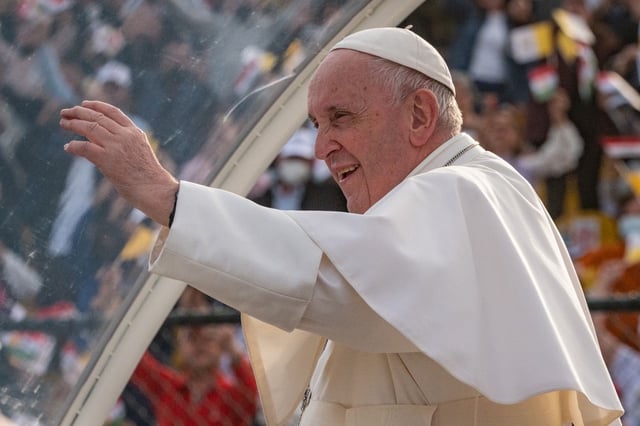 07 March 2021, Iraq, Erbil: Pope Francis waves from his popemobile to the cheering attendees as he arrives at Erbil’s Franso Hariri  Stadium to lead a mass as part of his visit to the autonomous Kurdistan Region in northern Iraq. Pope Francis arrived in Iraq on Friday for the first-ever papal visit to the Middle Eastern country, a place where the Christian community has dwindled amid years of war. Photo: STR/dpa (Photo by STR/picture alliance via Getty Images)
