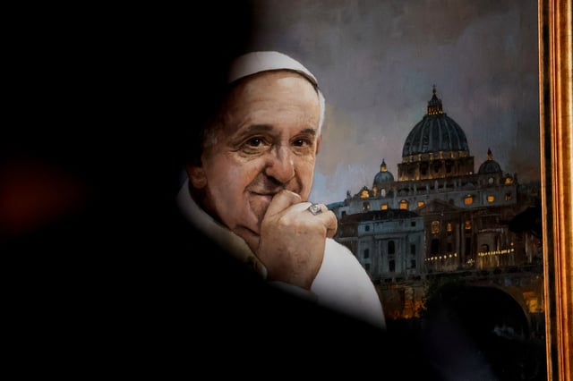 A portrait of Pope Francis is seen during a homage to him following his death, at La Esperanza's Basilica in Malaga, Spain April 22, 2025. REUTERS/Jon Nazca