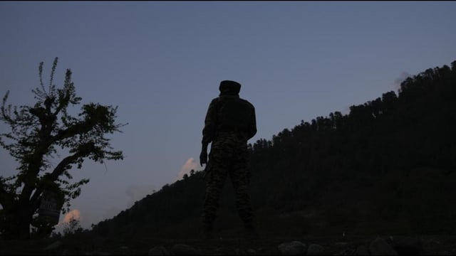 An Indian security officer stands guard in south Kashmir on Tuesday. (AP Photo)