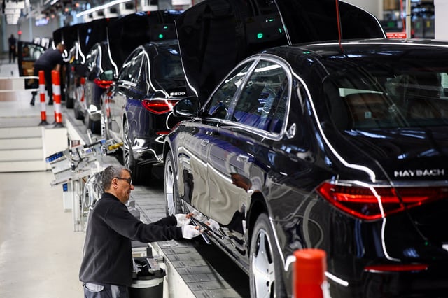 A worker attaches a part to a Mercedes-Maybach car on a production line of "Factory 56", one of the world's most modern electric and conventional car assembly halls of German carmaker Mercedes-Benz, in Sindelfingen near Stuttgart, Germany, March 4, 2024. REUTERS/Wolfgang Rattay/File Photo/File Photo