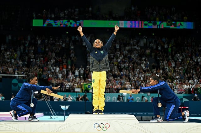 TOPSHOT - (LtoR) US' Simone Biles (silver), Brazil's Rebeca Andrade (gold) and US' Jordan Chiles (bronze) pose during the podium ceremony for the artistic gymnastics women's floor exercise event of the Paris 2024 Olympic Games at the Bercy Arena in Paris, on August 5, 2024. (Photo by Gabriel BOUYS / AFP) (Photo by GABRIEL BOUYS/AFP via Getty Images)