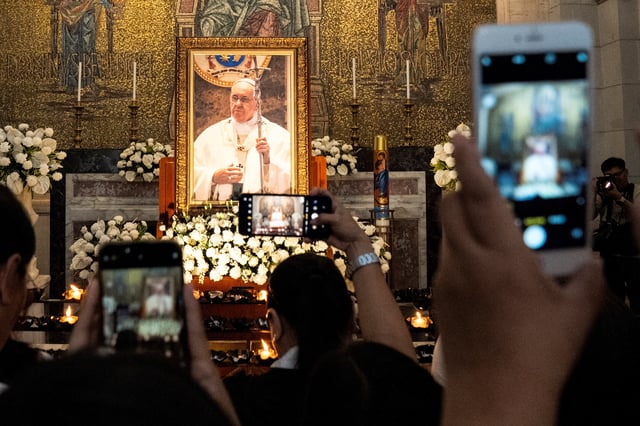 People take pictures of the image of Pope Francis displayed on the chapel of Manila Cathedral after the requiem mass, following the Pope's death, in Manila, Philippines, April 22, 2025. REUTERS/Lisa Marie David REUTERS