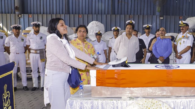Indian Navy Lt. Vinay Narwal's wife breaks down while paying tribute to her husband after his mortal remains were brought at the cargo terminal of IGI Airport, in New Delhi, Wednesday, April 23, 2025. Narwal was killed in the Tuesday's Pahalgam terror attack.