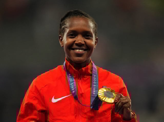 FILE PHOTO: Paris 2024 Olympics - Athletics - Women's 1500m Victory Ceremony - Stade de France, Saint-Denis, France - August 10, 2024.  Gold medallist Faith Kipyegon of Kenya celebrates on the podium. REUTERS/Aleksandra Szmigiel/File Photo