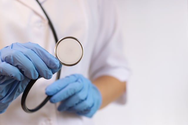 Stock image/file photo: Medical professional holding a stethoscope.