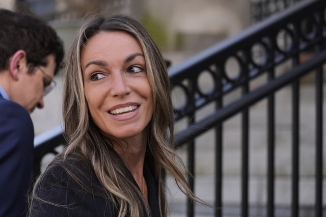 Karen Read chats with reporters while returning to court following the lunch break with her defense attorney Robert Alessi at her trial at Norfolk Superior Court, Tuesday, April 22, 2025, in Dedham, Mass.