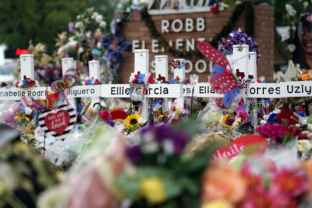 FILE - Crosses are surrounded by flowers and other items at a memorial, June 9, 2022, for the victims of a shooting at Robb Elementary School in Uvalde, Texas. (AP Photo/Eric Gay, File)