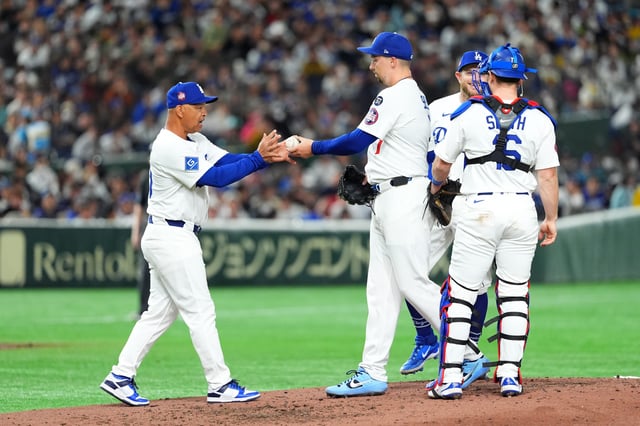 TOKYO, JAPAN - MARCH 16: Manager Dave Roberts #30 of the Los Angeles Dodgers receives the ball from Blake Snell #7 on the mound for the pitching change in the bottom of the fifth inning during the game against Hanshin Tigers at Tokyo Dome on March 16, 2025 in Tokyo, Japan.