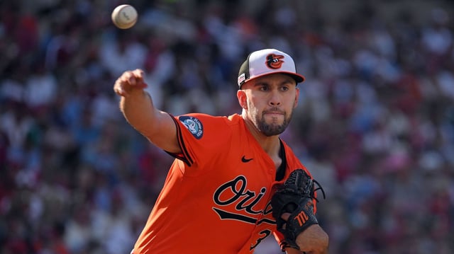Orioles pitcher Grayson Rodriguez throws to first to pick off Phillies runner Garrett Stubbs who stole second base when the ball to second hit him on the back in the seventh inning. defeated the Phillies 6-2 at Oriole Park at Camden Yards. (Kenneth K. Lam/Staff)